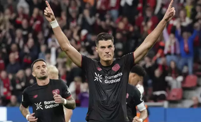 Leverkusen's Patrik Schick celebrates after he scored his side's second goal from the penalty spot during the German Bundesliga soccer match between Bayer Leverkusen and Eintracht Frankfurt at the BayArena in Leverkusen, Germany, Friday, Sept. 12, 2025. (AP Photo/Martin Meissner)