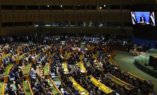 Palestinian President Mahmoud Abbas appears on a screen as he speaks virtually during a high-profile meeting at the United Nations aimed at galvanizing support for a two-state solution to the Israeli-Palestinian conflict Monday, Sept. 22, 2025, at UN headquarters (AP Photo/Yuki Iwamura)