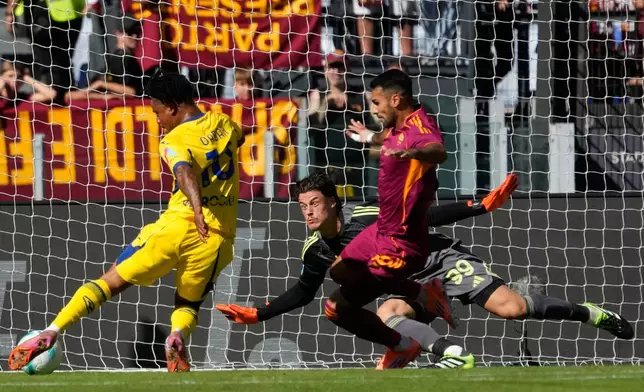 Roma's goalkeeper Mile Svilar, center, saves a shot by Verona's Gift Orban during the Serie A soccer match between Roma and Verona at Rome's Olympic Stadium, Sunday, Sept. 28, 2025. (AP Photo/Gregorio Borgia)