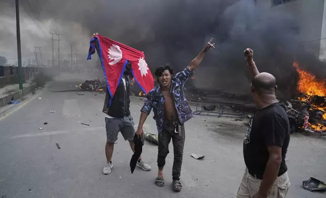 Protesters vandalize Nepalese congress party central office during protests against social media ban and corruption in Kathmandu, Nepal, Tuesday, Sept. 9, 2025. (AP Photo/Niranjan Shrestha)