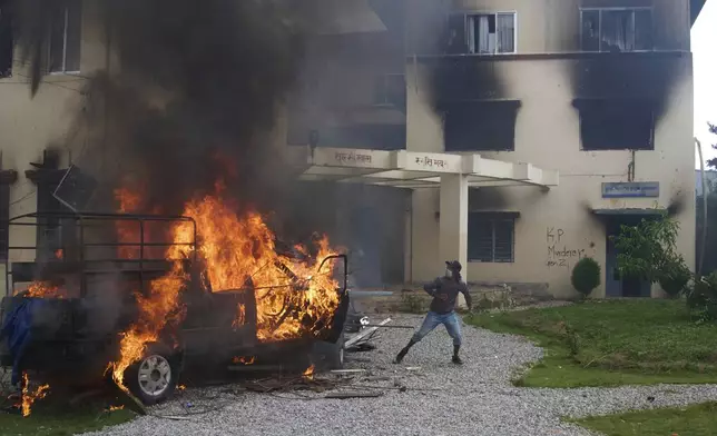 Protesters vandalize and burn down Nepalese communist party office during protests against social media ban and corruption in Kathmandu, Nepal, Tuesday, Sept. 9, 2025. (AP Photo/Niranjan Shrestha)