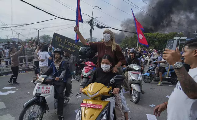 Protesters shout slogans during a protest against a social media ban and corruption in Kathmandu, Nepal, Tuesday, Sept. 9, 2025. (AP Photo/Niranjan Shrestha)