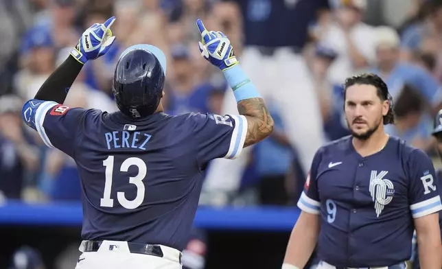 Kansas City Royals' Salvador Perez (13) celebrates as he crosses the plate after hitting a three-run home run during the first inning of a baseball game against the Toronto Blue Jays, Friday, Sept. 19, 2025, in Kansas City, Mo. (AP Photo/Charlie Riedel)