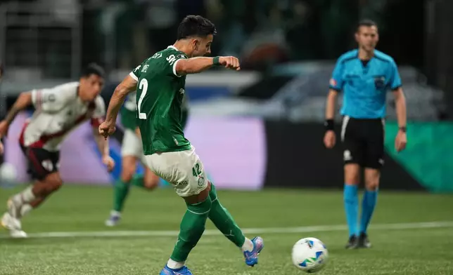 Jose Manuel Lopez of Brazil's Palmeiras scores from the penalty spot against Argentina's River Plate during a Copa Libertadores quarterfinal second leg soccer match at Allianz Parque stadium in Sao Paulo, Wednesday, Sept. 24, 2025. (AP Photo/Andre Penner)