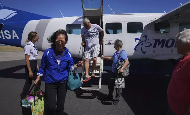 FILE - Kyong Son Toyofuku, second from left, and her husband, Lance Toyofuku, center, arrive at the former leprosy colony of Kalaupapa, Hawaii, July 18, 2023, with sisters and residents of the settlement, Alicia Damien Lau, second from right, and Barbara Jean Wajda, right. (AP Photo/Jessie Wardarski, File)