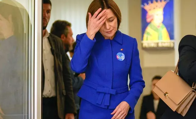 Moldova's President Maia Sandu exits a voting station after casting her vote during a parliamentary election, in Chisinau, Moldova, Sunday, Sept. 28, 2025. (AP Photo/Vadim Ghirda)