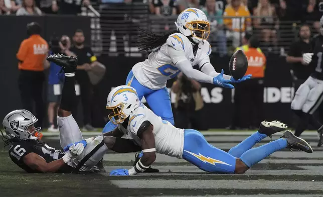 Los Angeles Chargers cornerback Donte Jackson (26) intercepts a pass intended for Las Vegas Raiders wide receiver Jakobi Meyers (16) during the second half of an NFL football game, Monday, Sept. 15, 2025, in Las Vegas. (AP Photo/Rick Scuteri)