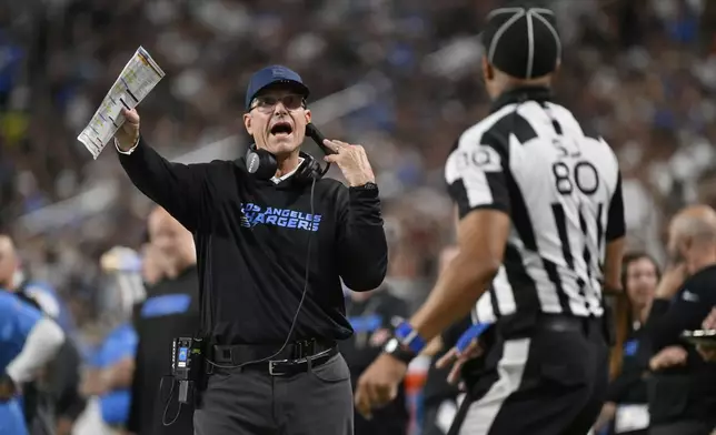 Los Angeles Chargers head coach Jim Harbaugh motions towards an official during the first half of an NFL football game against the Las Vegas Raiders, Monday, Sept. 15, 2025, in Las Vegas. (AP Photo/David Becker)
