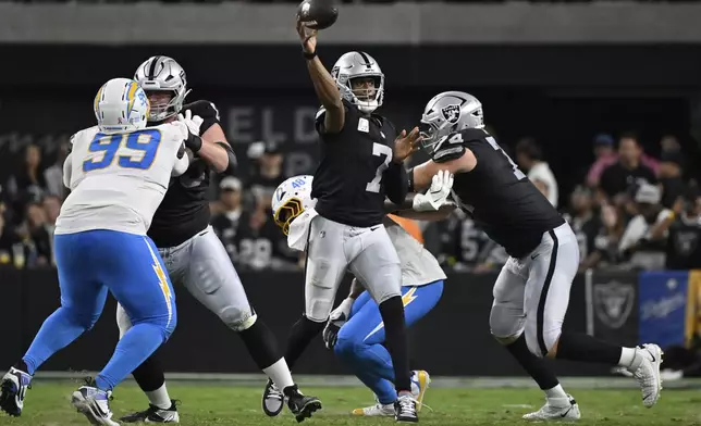 Las Vegas Raiders quarterback Geno Smith (7) throws against the Los Angeles Chargers during the first half of an NFL football game, Monday, Sept. 15, 2025, in Las Vegas. (AP Photo/David Becker)