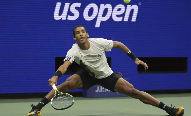 Felix Auger-Aliassime, of Canada, returns a shot against Jannik Sinner, of Italy, during the men's singles semifinals of the U.S. Open tennis championships, Friday, Sept. 5, 2025, in New York. (AP Photo/Frank Franklin II)