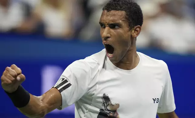 Felix Auger-Aliassime, of Canada, reacts against Jannik Sinner, of Italy, during the men's singles semifinals of the U.S. Open tennis championships, Friday, Sept. 5, 2025, in New York. (AP Photo/Frank Franklin)