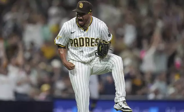 San Diego Padres relief pitcher Bradgley Rodriguez celebrates after the third out during the eleventh inning of a baseball game against the Milwaukee Brewers Monday, Sept. 22, 2025, in San Diego. (AP Photo/Gregory Bull)