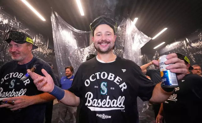Seattle Mariners catcher Cal Raleigh celebrates after the team's win in a baseball game against the Colorado Rockies to clinch a playoff spot, Tuesday, Sept. 23, 2025, in Seattle. (AP Photo/Ryan Sun)