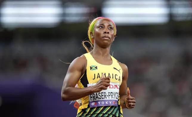 Jamaica's Shelly-Ann Fraser-Pryce looks up after finishing a women's 100 meters heat at the World Athletics Championships in Tokyo, Saturday, Sept. 13, 2025. (AP Photo/Petr David Josek)