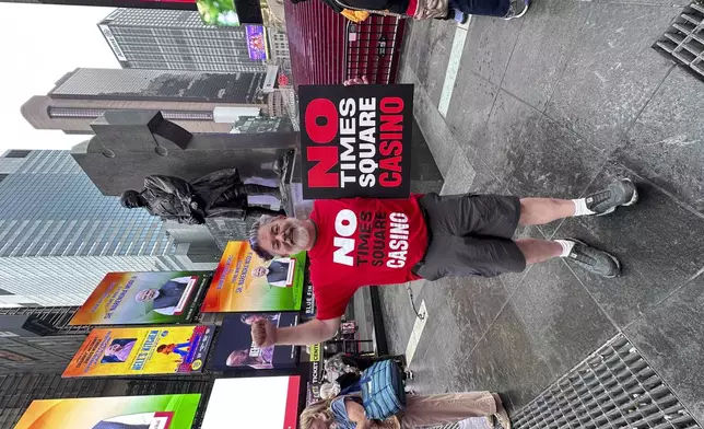 Bill Hubner, a casino opponent who works on costumes and wardrobes for Broadway shows, stands in Times Square on Wednesday, Sept. 17, 2025. (AP Photo/Philip Marcelo)