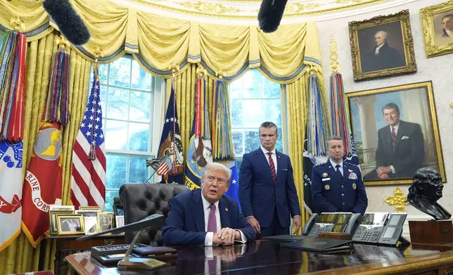 President Donald Trump speaks in the Oval Office of the White House, Friday, Sept. 5, 2025, in Washington, as Defense Secretary Pete Hegseth and Chairman of the Joint Chiefs of Staff Gen. Dan Caine listen. (AP Photo/Alex Brandon)