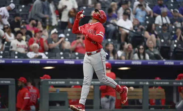 ADDS THAT IT WAS A TWO-RUN HOME RUN - Los Angeles Angels' Christian Moore celebrates while approaching home plate on a two-run home run in the second inning of a baseball game against the Colorado Rockies, Friday, Sept. 19, 2025, in Denver. (AP Photo/Geneva Heffernan)