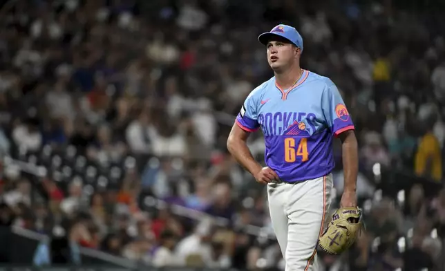 Colorado Rockies starting pitcher Bradley Blalock walks to the dugout after retiring the side in the fifth inning of a baseball game against the Los Angeles Angels, Friday, Sept. 19, 2025, in Denver. (AP Photo/Geneva Heffernan)