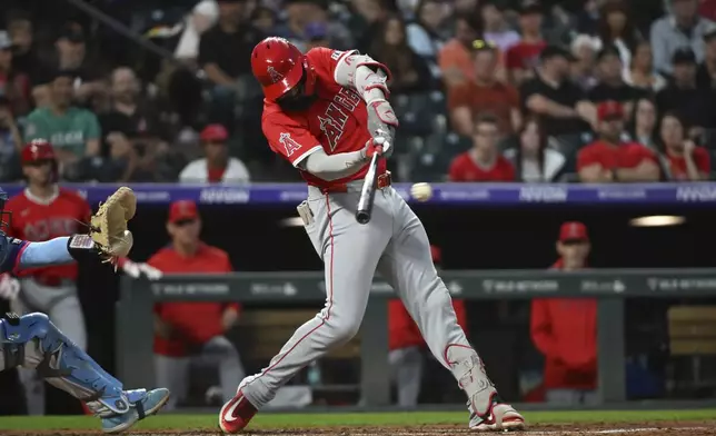 Los Angeles Angels' Jo Adell hits a single in the fourth inning of a baseball game against the Colorado Rockies Friday, Sept. 19, 2025, in Denver. (AP Photo/Geneva Heffernan)