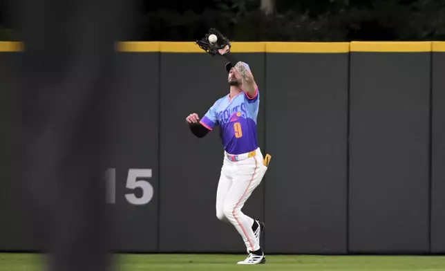 Colorado Rockies center fielder Brenton Doyle catches a sacrifice fly in the fifth inning of a baseball game against the Los Angeles Angels Friday, Sept. 19, 2025, in Denver. (AP Photo/Geneva Heffernan)