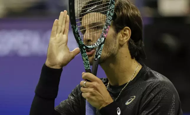 Lorenzo Musetti, of Italy, reacts during a match against Jannik Sinner, of Italy, at the quarterfinal round of the U.S. Open tennis championships, Wednesday, Sept. 3, 2025, in New York. (AP Photo/Adam Hunger)