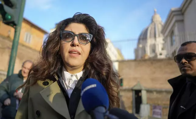 FILE - Public relations specialist Francesca Chaouqui talks to reporters as she arrives to testify in a trial at the Vatican, Jan. 13, 2023. (AP Photo/Andrew Medichini, File)