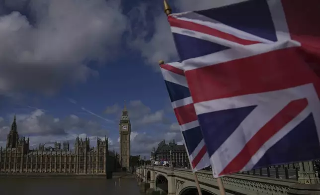 Union flag is seen in front of the House of Parliament in London, Monday, Sept. 1, 2025. (AP Photo/Kin Cheung)