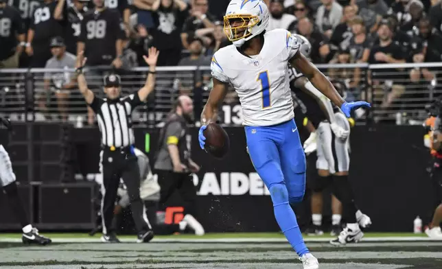 Los Angeles Chargers wide receiver Quentin Johnston (1) celebrates after scoring a touchdown against the Las Vegas Raiders during the first half of an NFL football game, Monday, Sept. 15, 2025, in Las Vegas. (AP Photo/David Becker)
