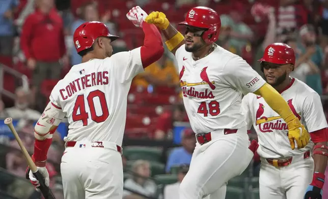 St. Louis Cardinals' Ivan Herrera (48) is congratulated by teammate Willson Contreras (40) after hitting a two-run home run during the sixth inning of a baseball game against the Athletics Tuesday, Sept. 2, 2025, in St. Louis. (AP Photo/Jeff Roberson)