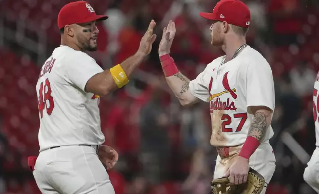 St. Louis Cardinals' Ivan Herrera (48) and Nathan Church (27) celebrate a victory over the Athletics in a baseball game Tuesday, Sept. 2, 2025, in St. Louis. (AP Photo/Jeff Roberson)