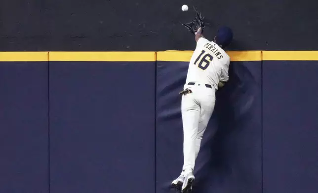 Milwaukee Brewers' Blake Perkins can't catch a home run hit by Los Angeles Angels' Denzer Guzman during the fifth inning of a baseball game Tuesday, Sept. 16, 2025, in Milwaukee. (AP Photo/Morry Gash)