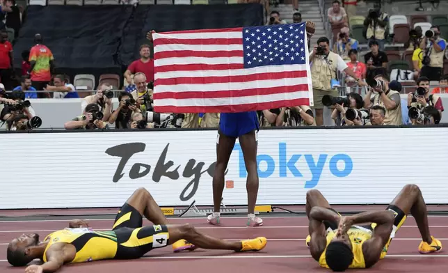 United States' Cordell Tinch poses for photos after winning the men's 110 meters hurdles final at the World Athletics Championships in Tokyo, Tuesday, Sept. 16, 2025. (AP Photo/Ashley Landis)