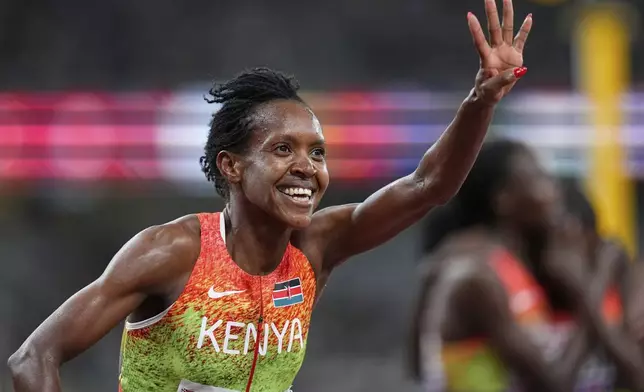 Kenya's Faith Kipyegon celebrates winning the gold in the women's 1,500 meters final at the World Athletics Championships in Tokyo, Tuesday, Sept. 16, 2025. (AP Photo/Petr David Josek)