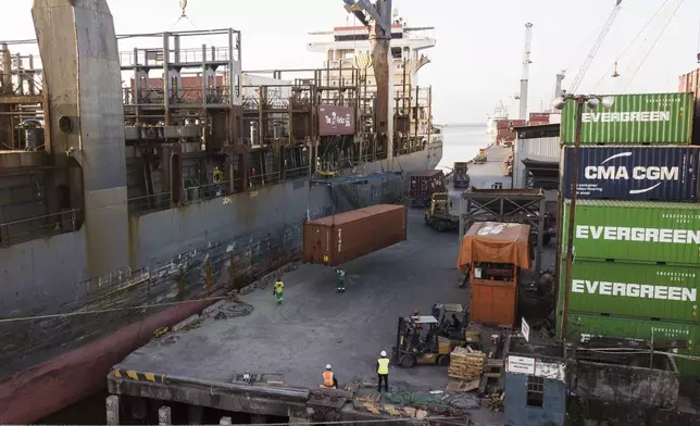 A container is loaded onto a cargo ship a day ahead of general elections in Georgetown, Guyana, Sunday, Aug. 31, 2025. (AP Photo/Matias Delacroix)