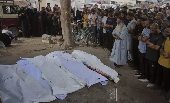 Palestinians mourn over the bodies of people who were killed in an Israeli army strike, during their funeral outside Shifa Hospital in Gaza City, Thursday, Sept. 4, 2025. (AP Photo/Jehad Alshrafi)