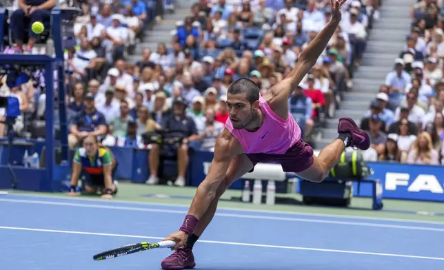 Carlos Alcaraz, of Spain, returns a shot to Jiri Lehecka, of the Czech Republic, during the quarterfinal round of the U.S. Open tennis championships, Tuesday, Sept. 2, 2025, in New York. (AP Photo/Kirsty Wigglesworth)