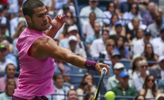 Carlos Alcaraz, of Spain, returns a shot to Jiri Lehecka, of the Czech Republic, during the quarterfinal round of the U.S. Open tennis championships, Tuesday, Sept. 2, 2025, in New York. (AP Photo/Heather Khalifa)