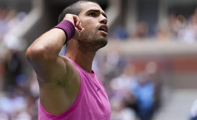 Carlos Alcaraz, of Spain, reacts after scoring a point against Jiri Lehecka, of the Czech Republic, during the quarterfinal round of the U.S. Open tennis championships, Tuesday, Sept. 2, 2025, in New York. (AP Photo/Kirsty Wigglesworth)