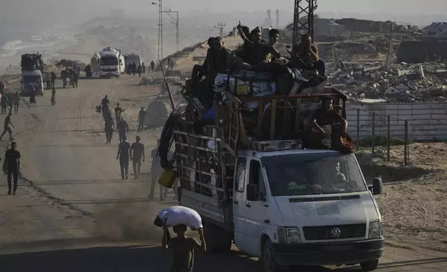 Displaced Palestinians flee Gaza City by foot and vehicles, carrying their belongings along the coastal road toward southern Gaza, Wednesday, Sept. 17, 2025. (AP Photo/Abdel Kareem Hana)