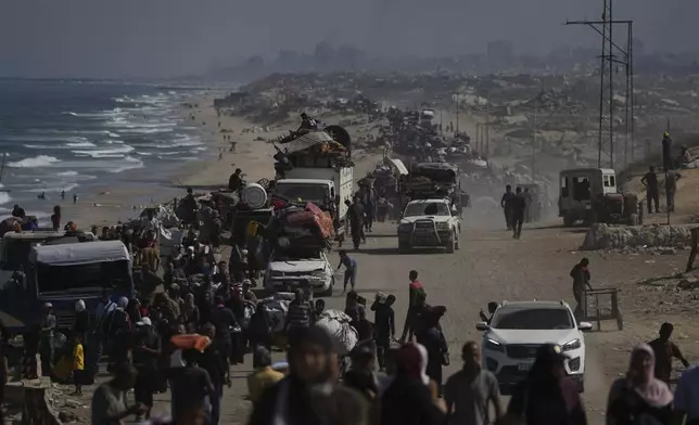 Displaced Palestinians flee Gaza City by foot and vehicles, carrying their belongings along the coastal road toward southern Gaza, Wednesday, Sept. 17, 2025. (AP Photo/Abdel Kareem Hana)