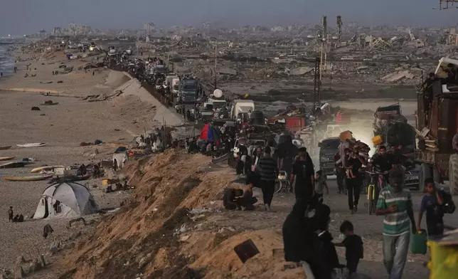 Displaced Palestinians flee northern Gaza along the coastal road toward the south, as Israel announced an expanded operation in Gaza City, Tuesday, Sept. 16, 2025. (AP Photo/Abdel Kareem Hana)