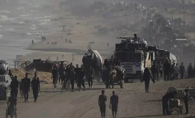 Displaced Palestinians flee Gaza City by foot and vehicles, carrying their belongings along the coastal road toward southern Gaza, Wednesday, Sept. 17, 2025. (AP Photo/Abdel Kareem Hana)