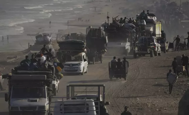 Displaced Palestinians flee Gaza City by foot and vehicles, carrying their belongings along the coastal road toward southern Gaza, Wednesday, Sept. 17, 2025. (AP Photo/Abdel Kareem Hana)