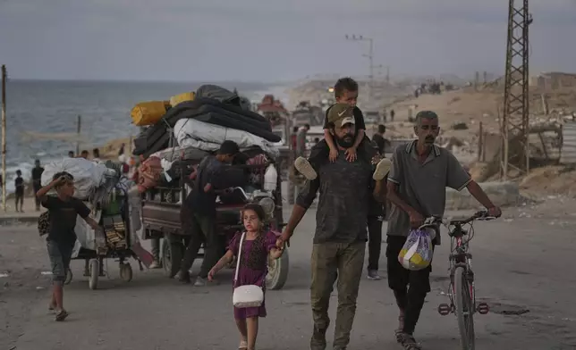 Displaced Palestinians flee northern Gaza along the coastal road toward the south, as Israel announced an expanded operation in Gaza City, Tuesday, Sept. 16, 2025. (AP Photo/Abdel Kareem Hana)