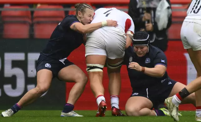 England's Morwenna Talling center, is stopped during the Women's Rugby World Cup 2025 quarterfinal match between England and Scotland in Bristol, England, Sunday, Sept. 14, 2025.(AP Photo/Anthony Upton)