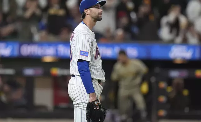 New York Mets pitcher David Peterson reacts as San Diego Padres' Manny Machado runs the bases after hitting a grand slam during the fifth inning of a baseball game Wednesday, Sept. 17, 2025, in New York. (AP Photo/Frank Franklin II)
