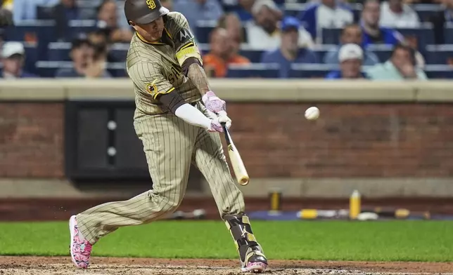 San Diego Padres' Manny Machado hits a grand slam during the fifth inning of a baseball game against the New York Mets Wednesday, Sept. 17, 2025, in New York. (AP Photo/Frank Franklin II)