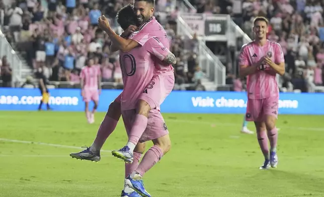 Inter Miami forward Lionel Messi, left, celebrates with defender Jordi Alba, right, after scoring a goal during the first half of an MLS soccer match against Seattle Sounders, Tuesday, Sept. 16, 2025, in Fort Lauderdale, Fla. (AP Photo/Lynne Sladky)