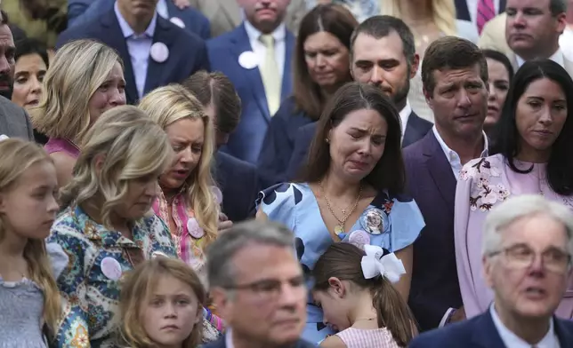 Parents and family of children who died at Camp Mystic, join Texas Gov. Greg Abbott as he signs camp safety bills, Friday, Sept. 5, 2025, in Austin, Texas. (AP Photo/Eric Gay)