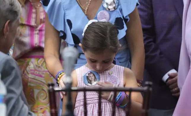 Texas Gov. Greg Abbott, left, visits with parents and family of children who died at Camp Mystic as he prepares to sign camp safety bills, Friday, Sept. 5, 2025, in Austin, Texas. (AP Photo/Eric Gay)